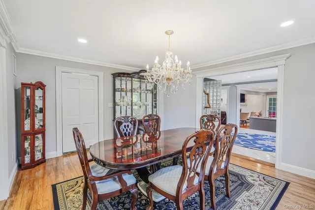 a view of a dining room with furniture and chandelier