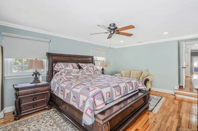 a bedroom with a bed next to a window