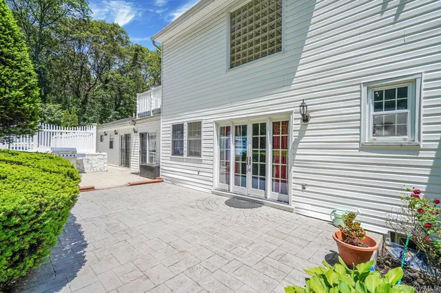 a front view of a house with a chairs in a patio