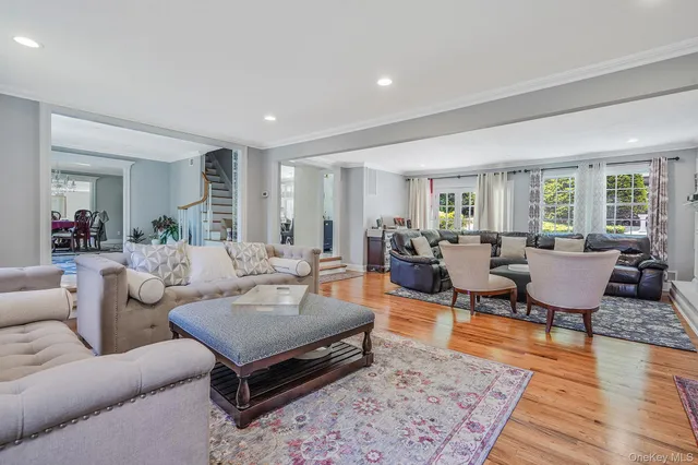 a living room with furniture a rug and a table
