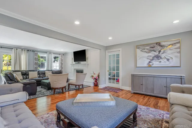 a living room with furniture a rug and a flat screen tv