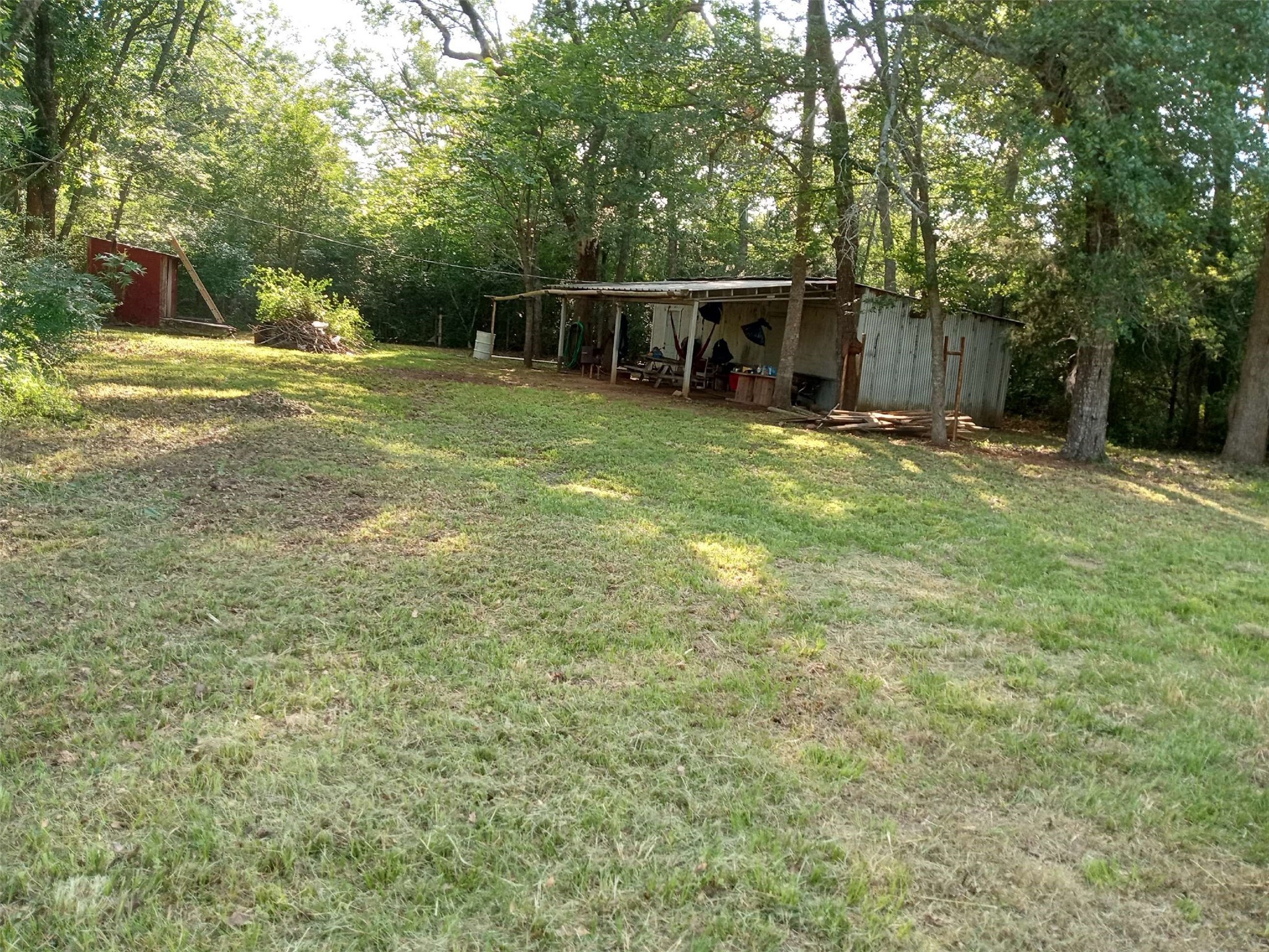 1100 Rd Leona Tx 75850 Road Leona, TX 75850 - Photo 4 of 12 a view of a backyard with large trees and wooden fence