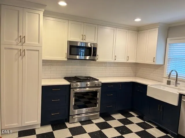 a kitchen with a sink a refrigerator and cabinets