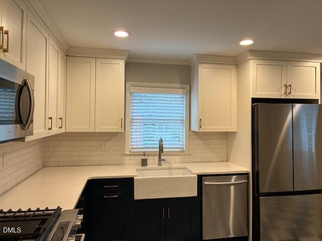 1212 Brookside Drive Raleigh, NC 27604 - Photo 13 of 42 a kitchen with stainless steel appliances granite countertop a sink stove and refrigerator