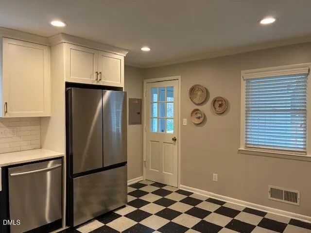 a spacious bedroom with a bed and wooden floor
