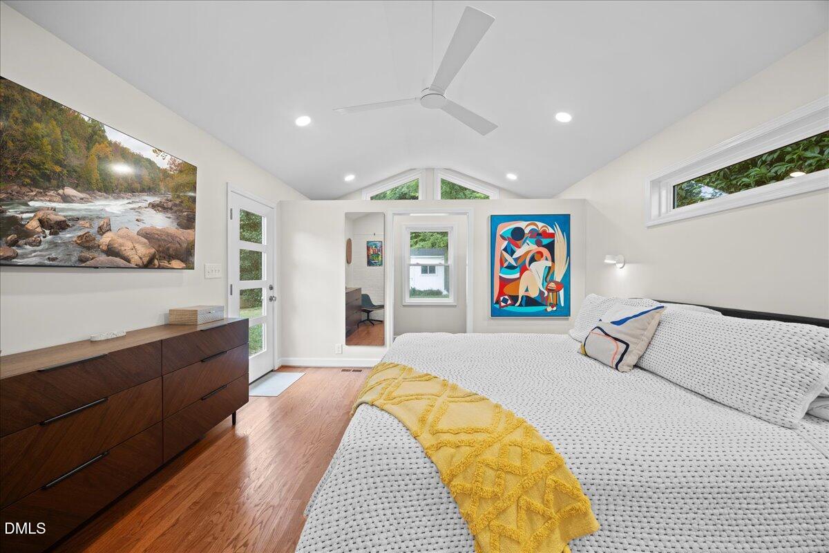 1212 Brookside Drive Raleigh, NC 27604 - Photo 17 of 42 a spacious bedroom with a bed and glass walk in closet