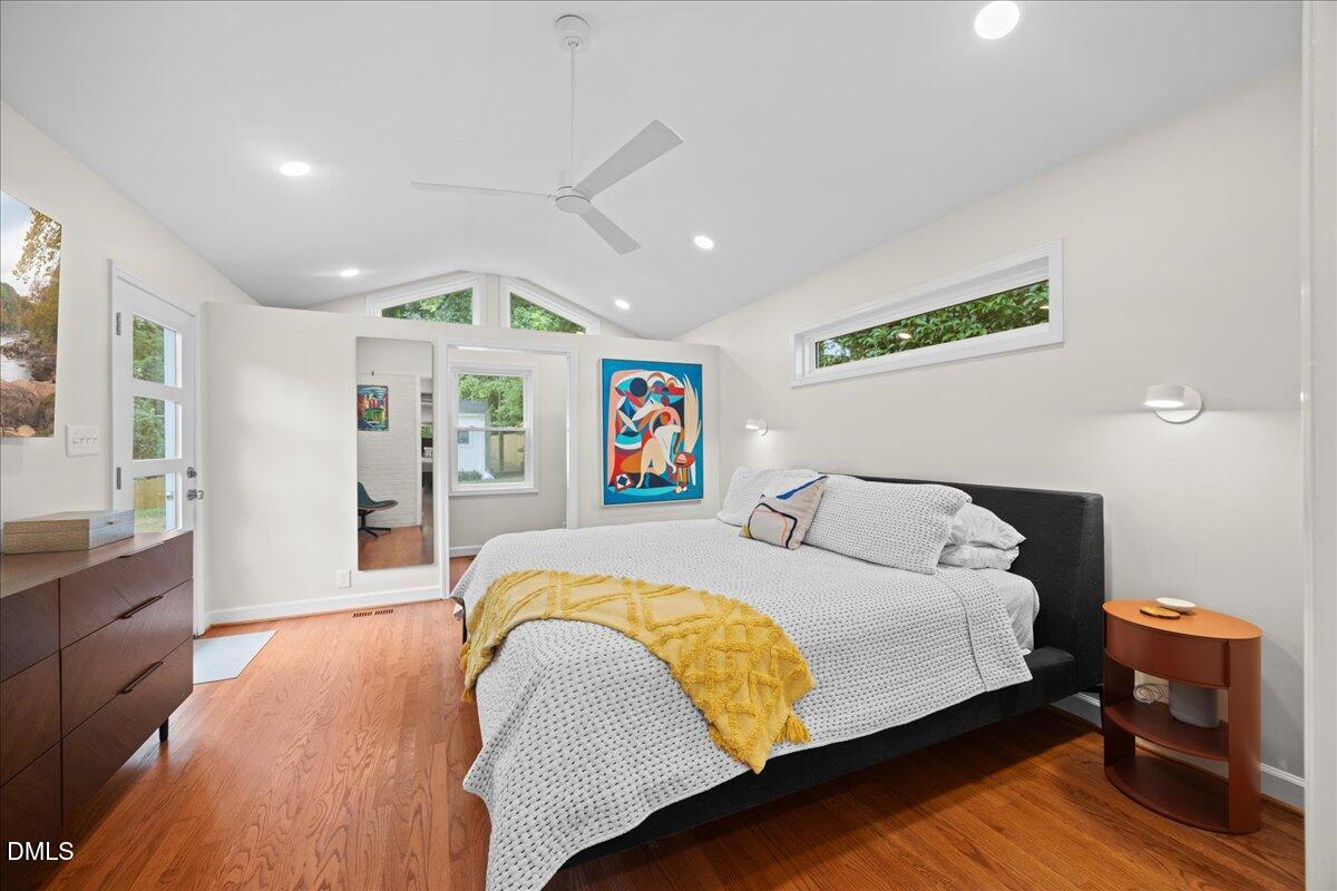 1212 Brookside Drive Raleigh, NC 27604 - Photo 18 of 42 a spacious bedroom with a bed and wooden floor
