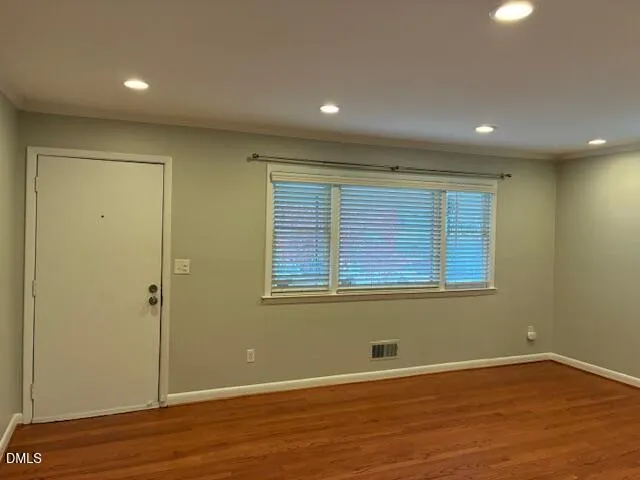 a kitchen with granite countertop stainless steel appliances a stove a sink a microwave a dining table and chairs