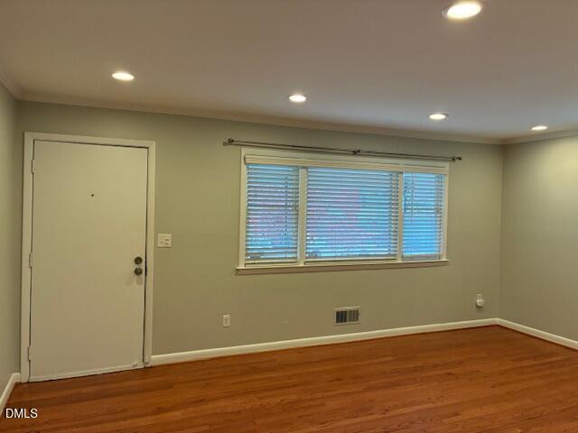 1212 Brookside Drive Raleigh, NC 27604 - Photo 6 of 42 a view of an empty room with wooden floor and a window
