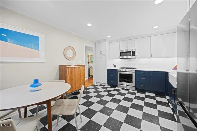 a kitchen with stainless steel appliances granite countertop a refrigerator and a stove