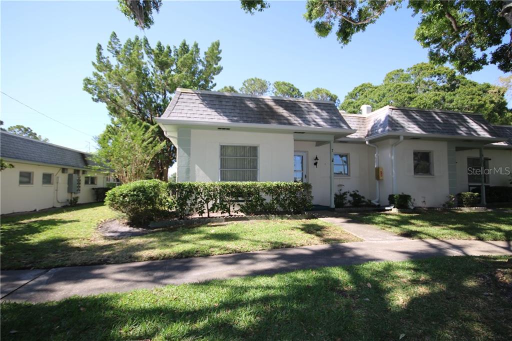 1466 Normandy Park Drive, Unit 7 Clearwater, FL 33756 - Photo 1 of 1 a front view of a house with a yard