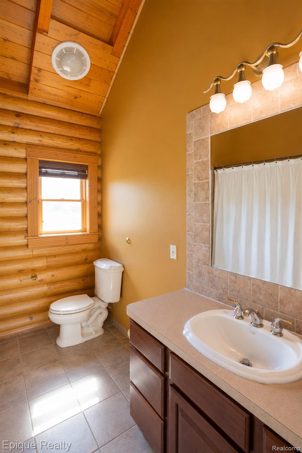 1966 Mayer Road Smiths Creek, MI 48074 - Photo 14 of 38 Bathroom featuring a vanity with an integrated sink, a large wall mirror with tiled surround, and a four-light fixture