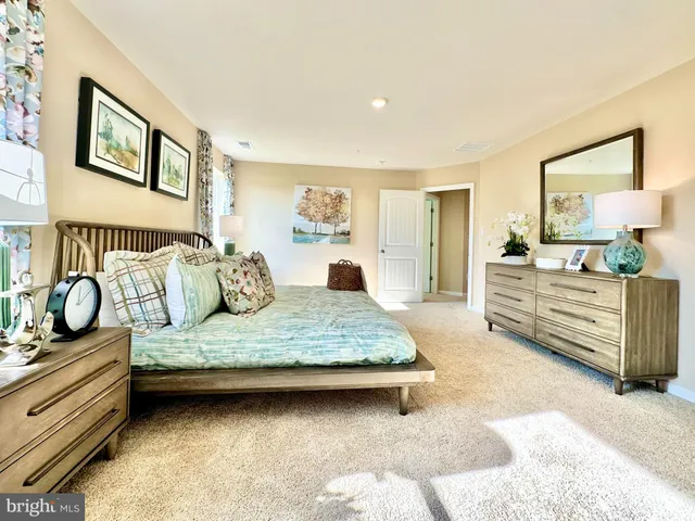 a bedroom with a bed and dresser