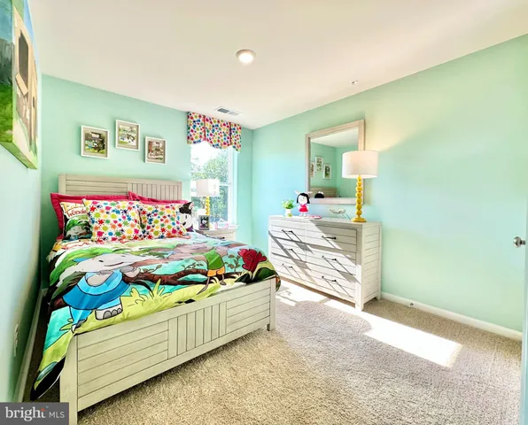 a bedroom with a bed that has a couch in it