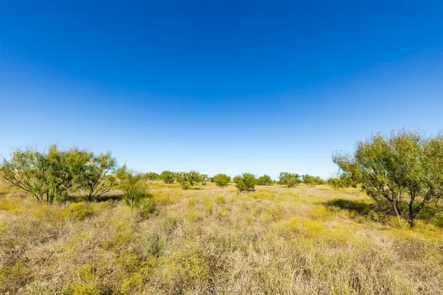 a view of a large body of water with a building in the background