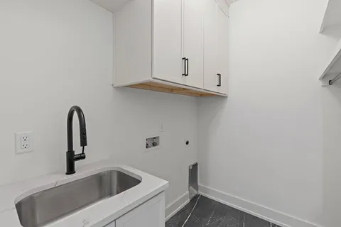 an empty room with wooden floor chandelier fan and windows