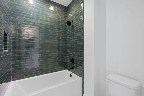a view of a room with wooden floor closet and windows