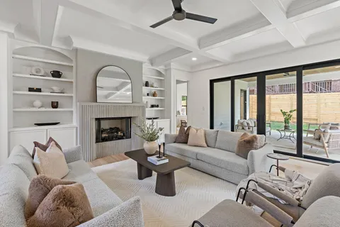 a living room with furniture fireplace and a large window