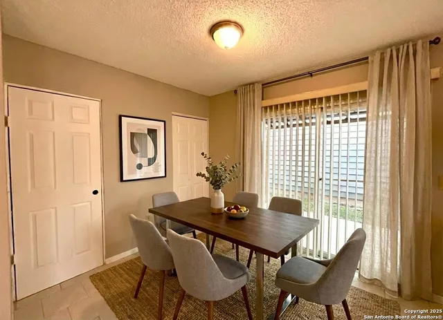 a view of a dining room with furniture window and outside view