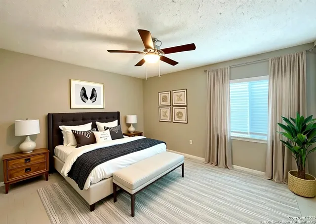 a bedroom with a large bed and a potted plant