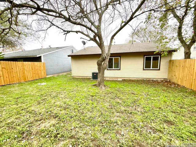 a house that has a tree in front of the house
