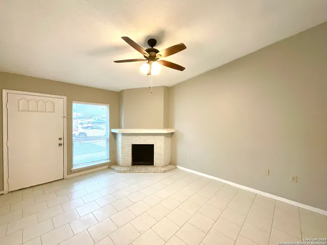 a view of an empty room with closet and a window