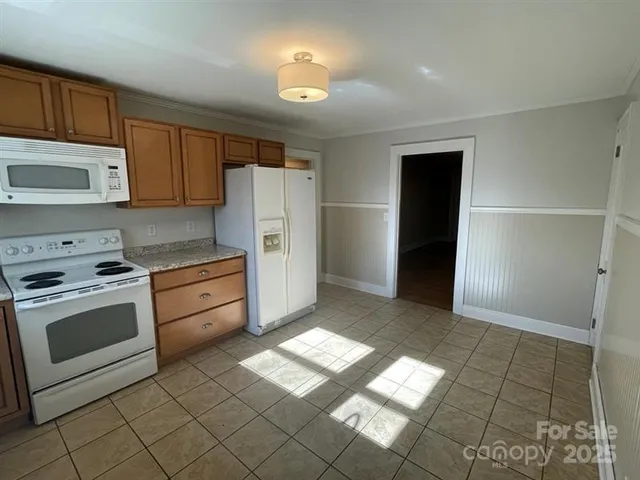 a bathroom with a toilet a sink a vanity and mirror
