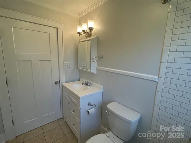 a bathroom with a sink a toilet a mirror a bathtub and shower