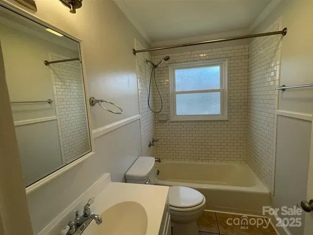 an empty room with wooden floor and fan