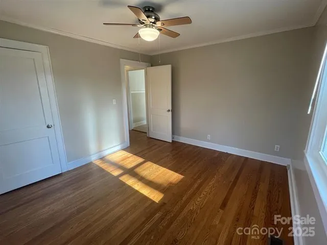 a view of wooden floor and windows in a room