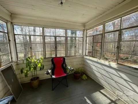 a view of empty room with wooden ceiling