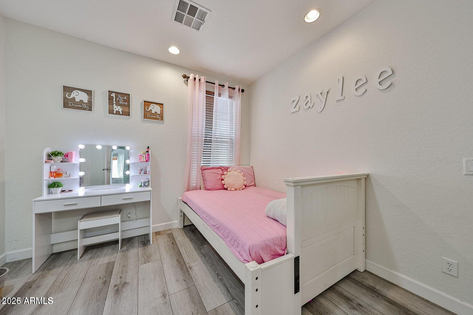 3950 North Edith Way Buckeye, AZ 85396 - Photo 18 of 32 a bedroom with a bed and a table