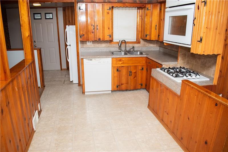 1924 Cherry Alley Monaca, PA 15061 - Photo 6 of 22 a kitchen with stainless steel appliances granite countertop a stove a sink and a refrigerator