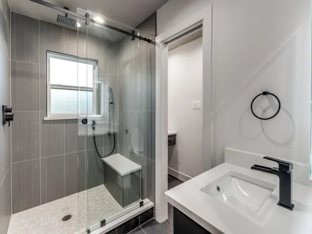 a bathroom with a sink toilet and shower