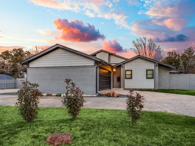 a backyard of a house with table and chairs