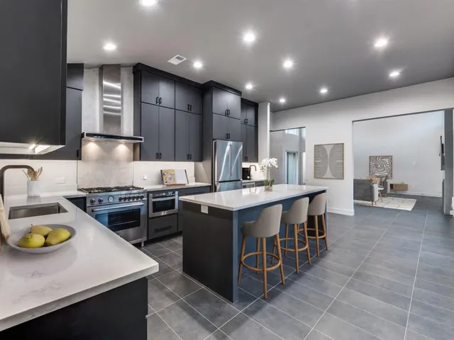 a kitchen with wooden cabinets and center island