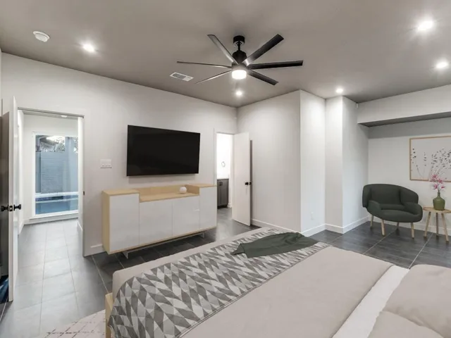 a bedroom with a bed and a flat screen tv