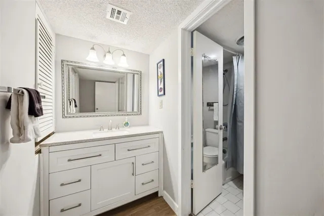 a bathroom with a double vanity sink and mirror