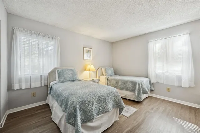 a bedroom with two beds and a large window