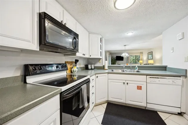 a kitchen with a sink stove and microwave