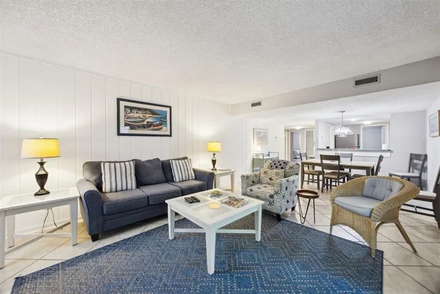 a living room with furniture and a lamp