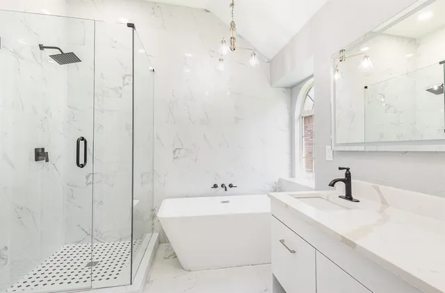 a bathroom with a sink a toilet a shower and a mirror