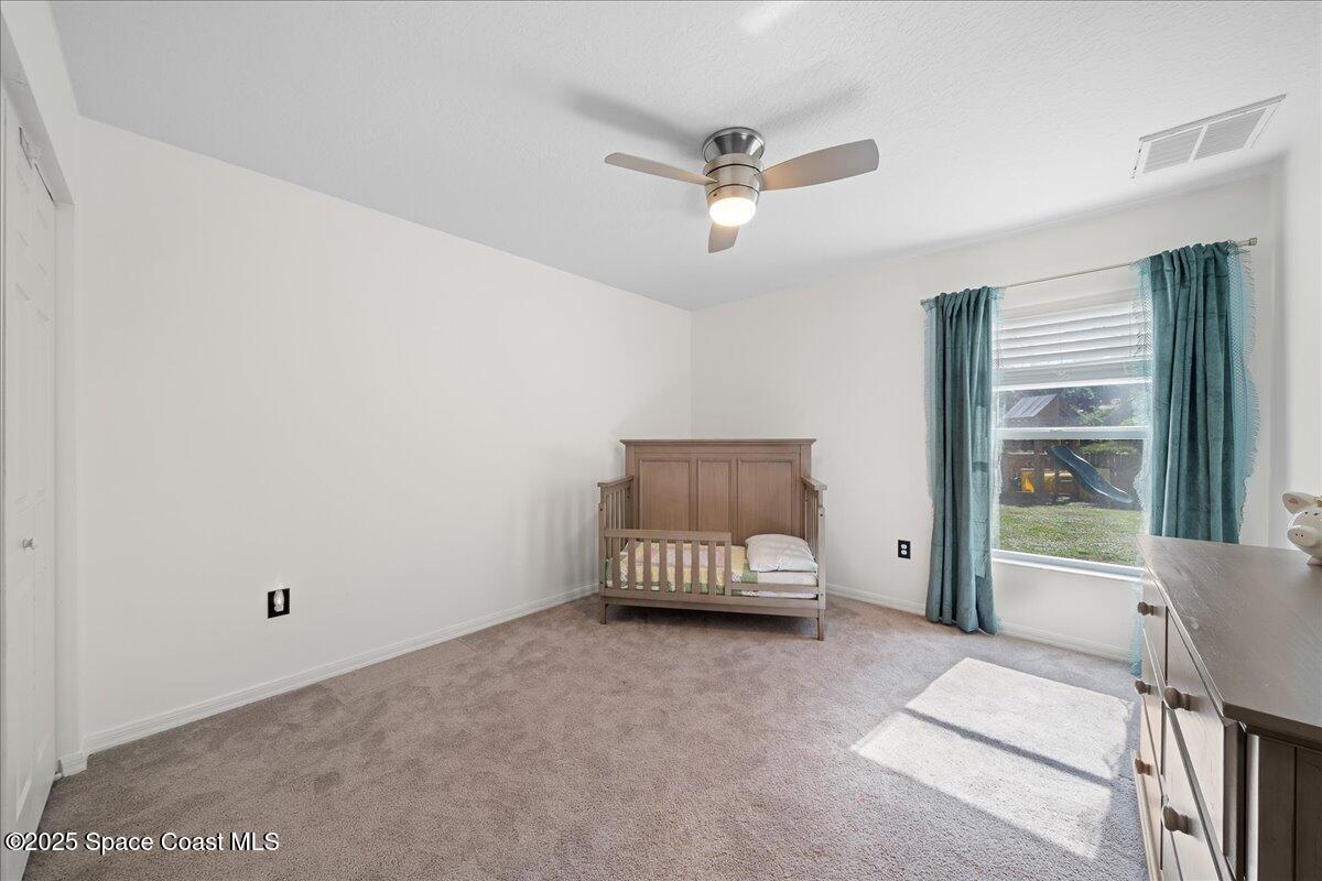 2409 Granger Road Cocoa, FL 32926 - Photo 13 of 36 a living room with a ceiling fan and a window