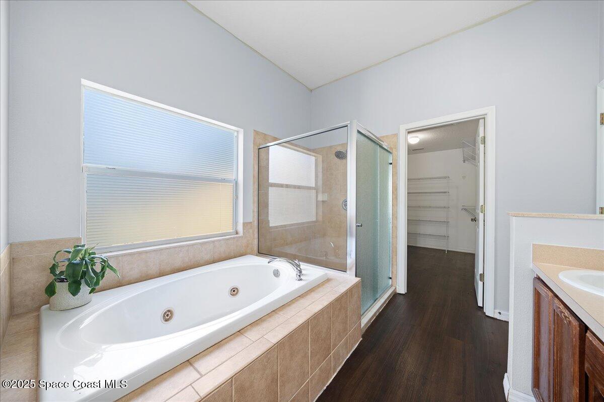 2409 Granger Road Cocoa, FL 32926 - Photo 19 of 36 a bathroom with a tub a sink and a large mirror