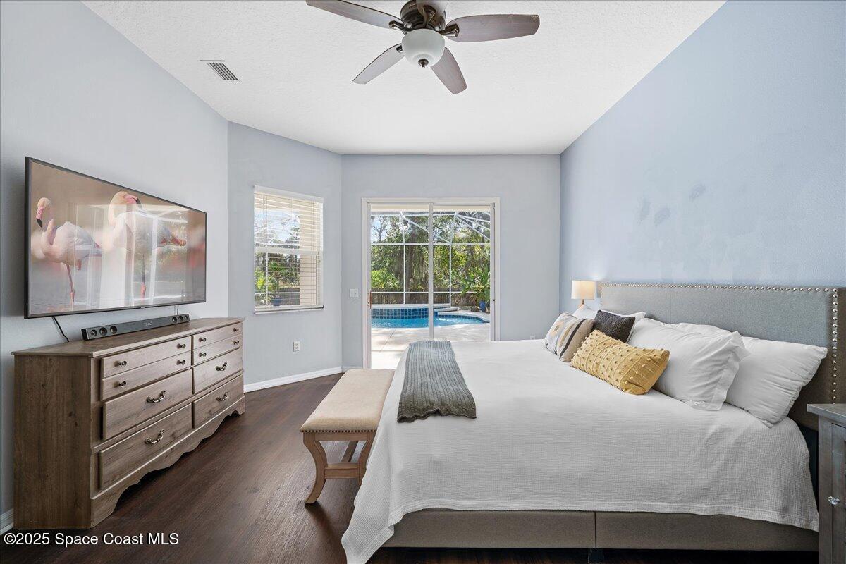 2409 Granger Road Cocoa, FL 32926 - Photo 23 of 36 a bedroom with a large bed and flat tv screen on the dresser