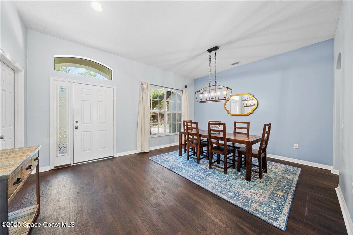 2409 Granger Road Cocoa, FL 32926 - Photo 29 of 36 a view of a dining room and hall with wooden floor