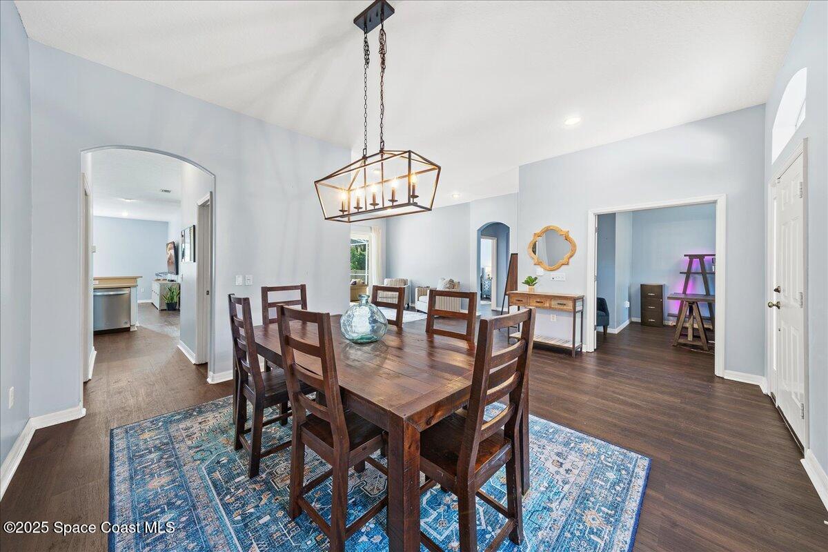 2409 Granger Road Cocoa, FL 32926 - Photo 30 of 36 a view of a dining room and livingroom with furniture wooden floor a chandelier
