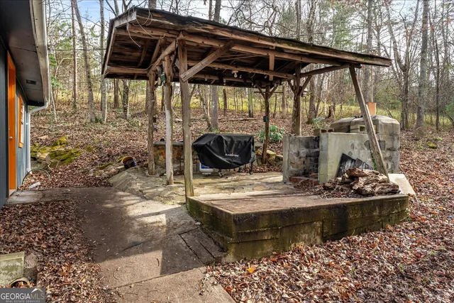 a view of house with backyard water fountain and sitting area