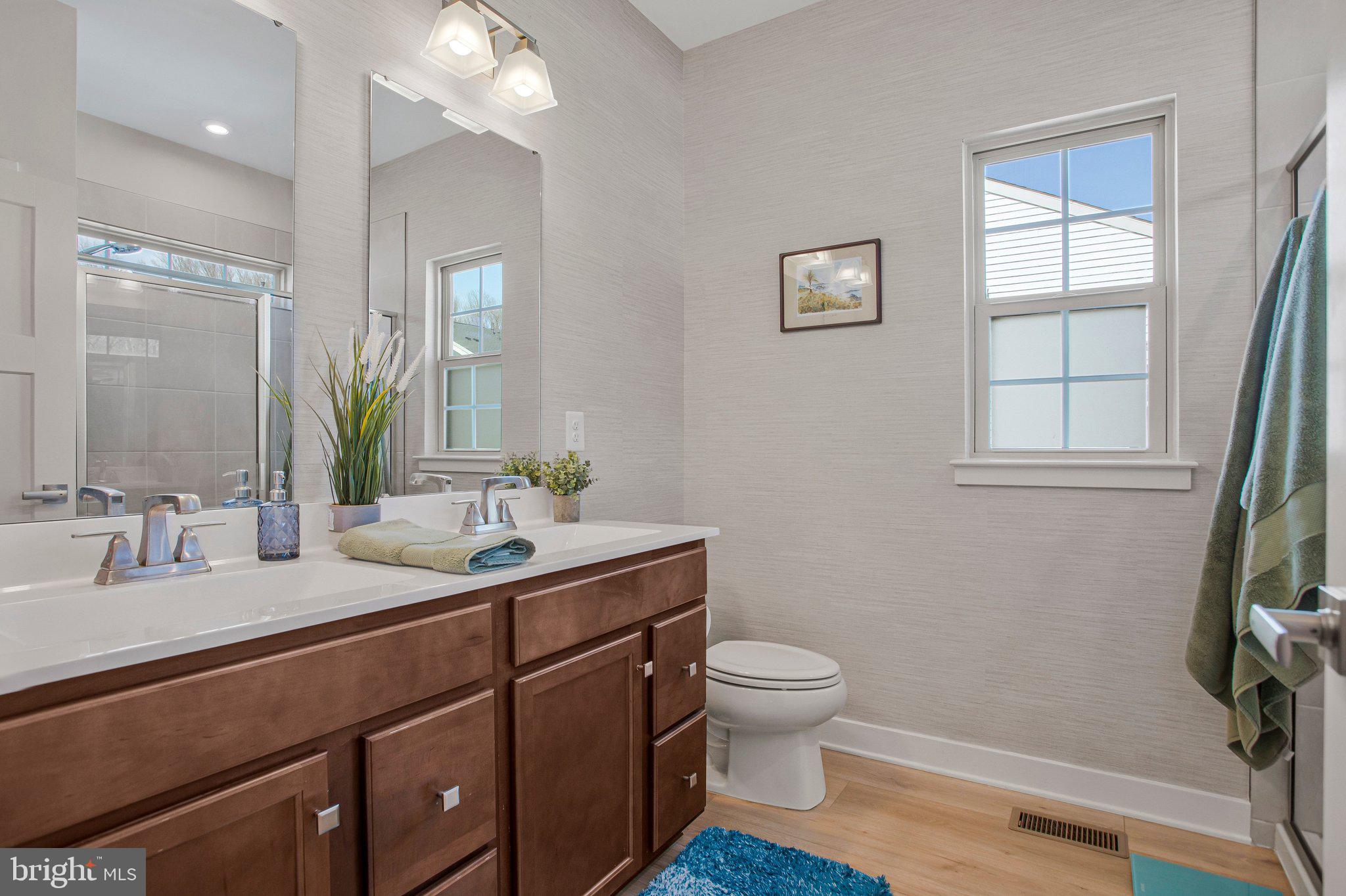 9012 Waller Tree Way Upper Marlboro, MD 20772 - Photo 13 of 29 a bathroom with a toilet sink and mirror