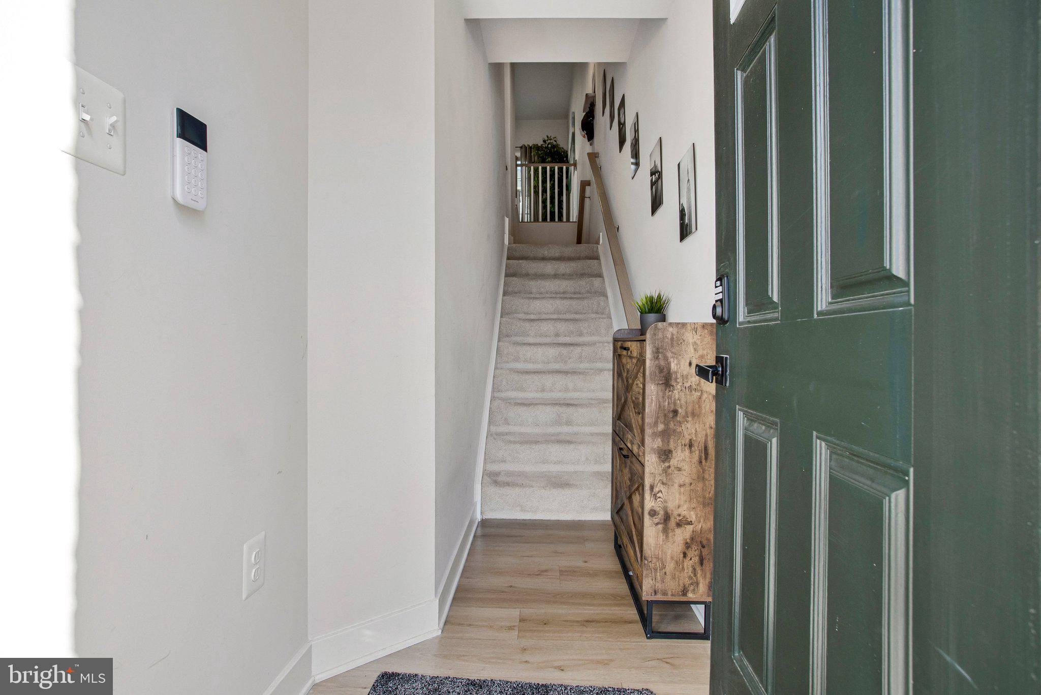 9012 Waller Tree Way Upper Marlboro, MD 20772 - Photo 2 of 29 a view of a hallway with white walls and stairs